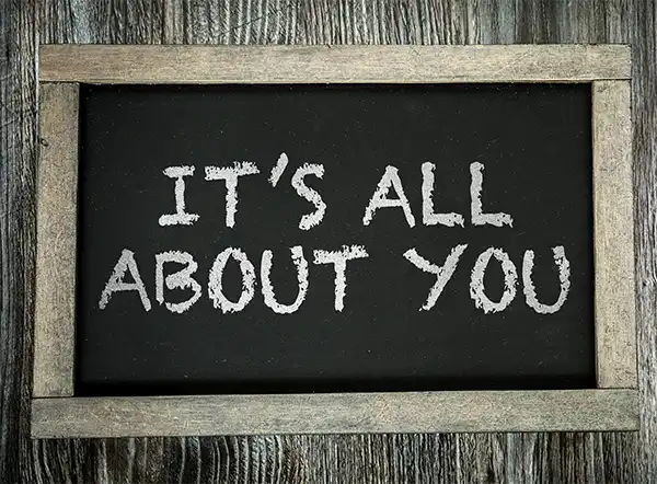 "It's all about you” written on a blackboard